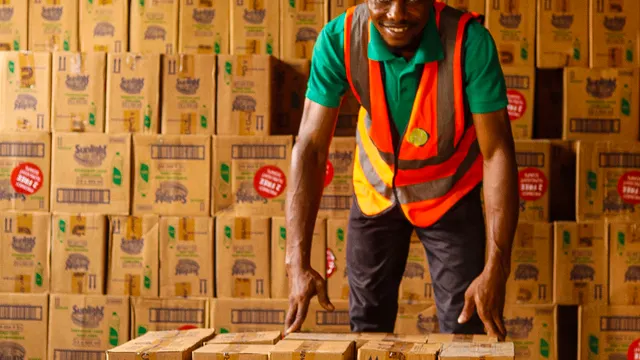 Logistics worker organizing packaged goods in a warehouse