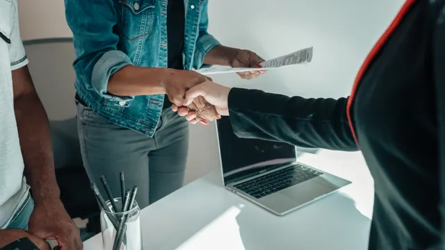 Recruiter welcoming a successful candidate with a handshake